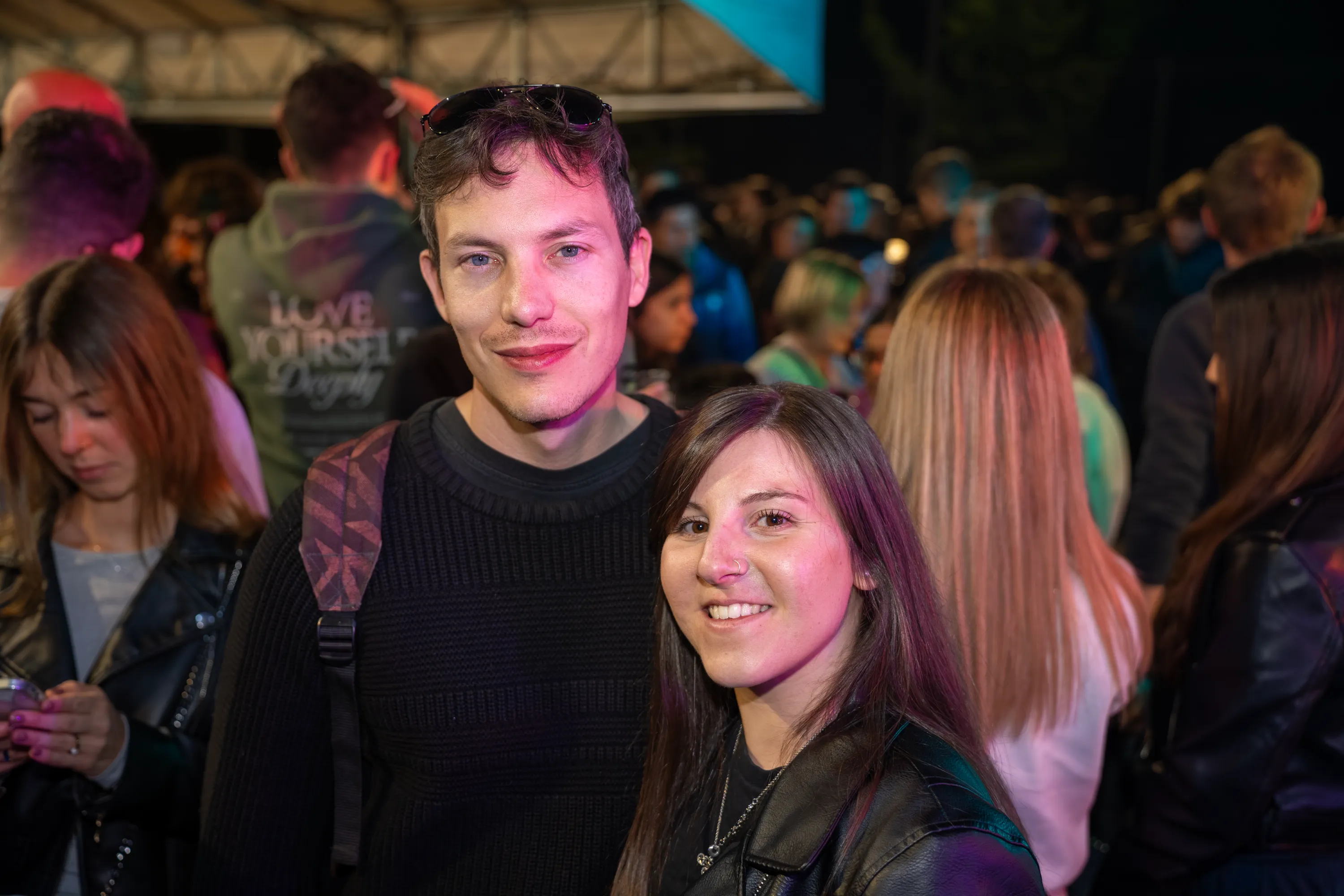 Due ragazzi sorridono in mezzo alla folla della serata