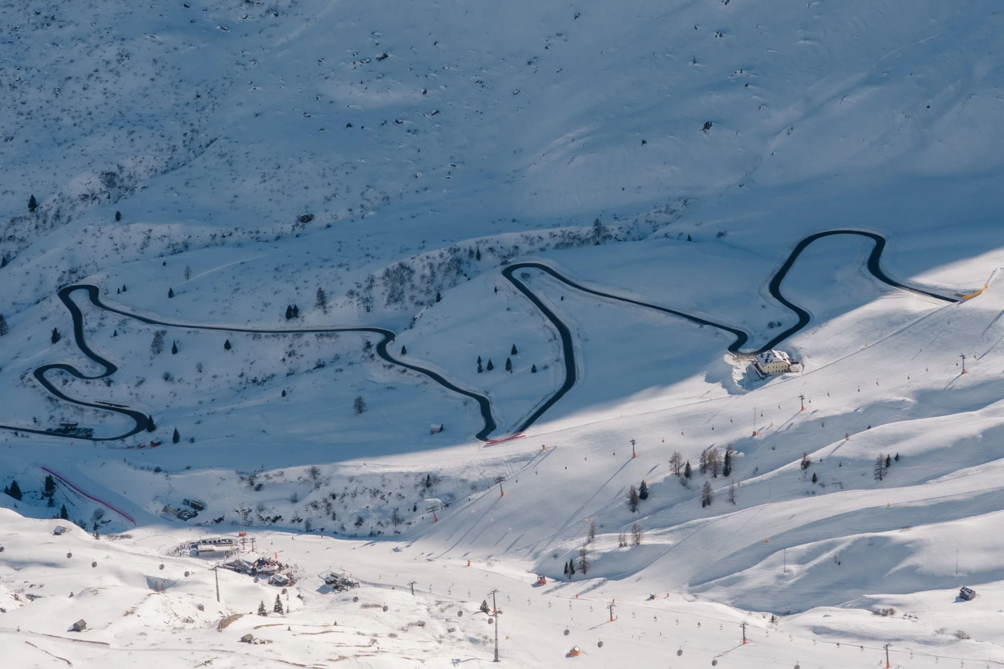 Dall'alto, le strade innevate di Pozza di Fassa d'inverno